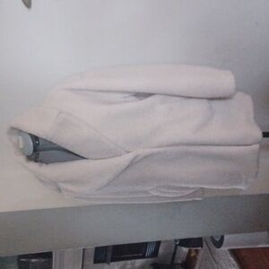 Car coat length, cream colored teddy coat.